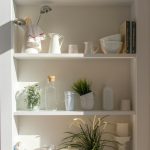 bowls and bottles in white wooden 4-layer shelf