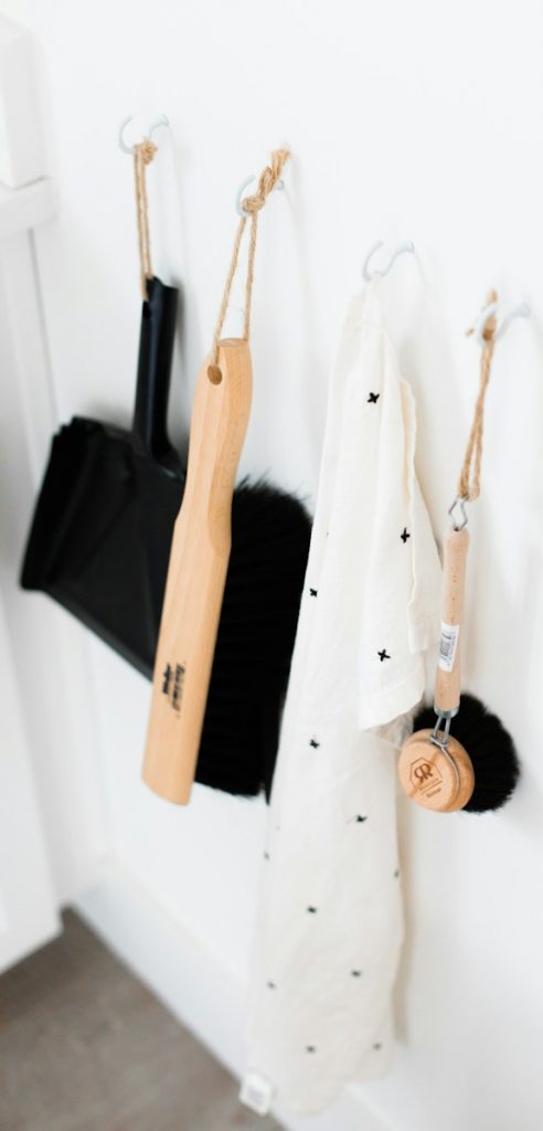 three black and brown bathroom cleaning tools